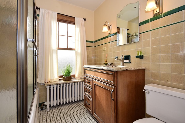 538 Byrd Road Riverside, IL 60546 - Photo 16 of 24 a bathroom with a sink toilet and window