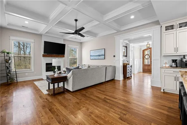 a living room with furniture a flat screen tv and a fireplace