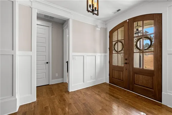 a view of a dining room with furniture large windows and wooden floor