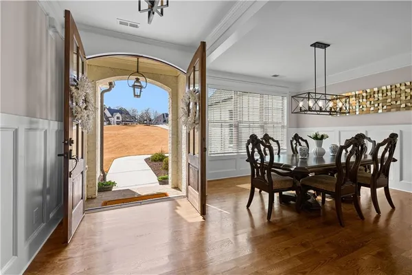 a large kitchen with stainless steel appliances granite countertop a sink dishwasher a refrigerator and wooden cabinets