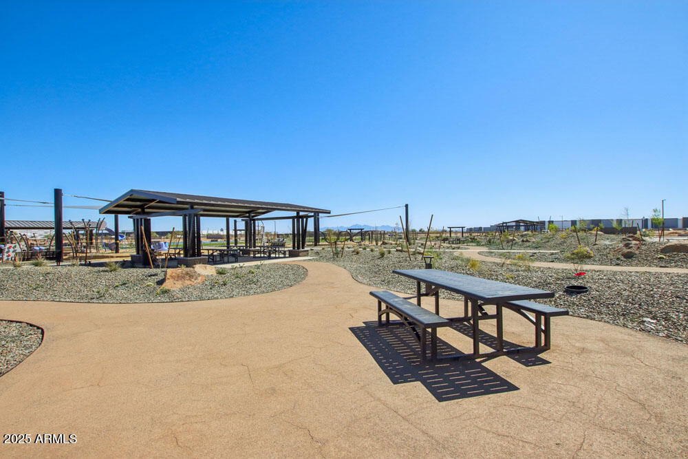 15718 West Corte Del Sol Este Waddell, AZ 85355 - Photo 5 of 14 a view of a swimming pool with a lounge chair