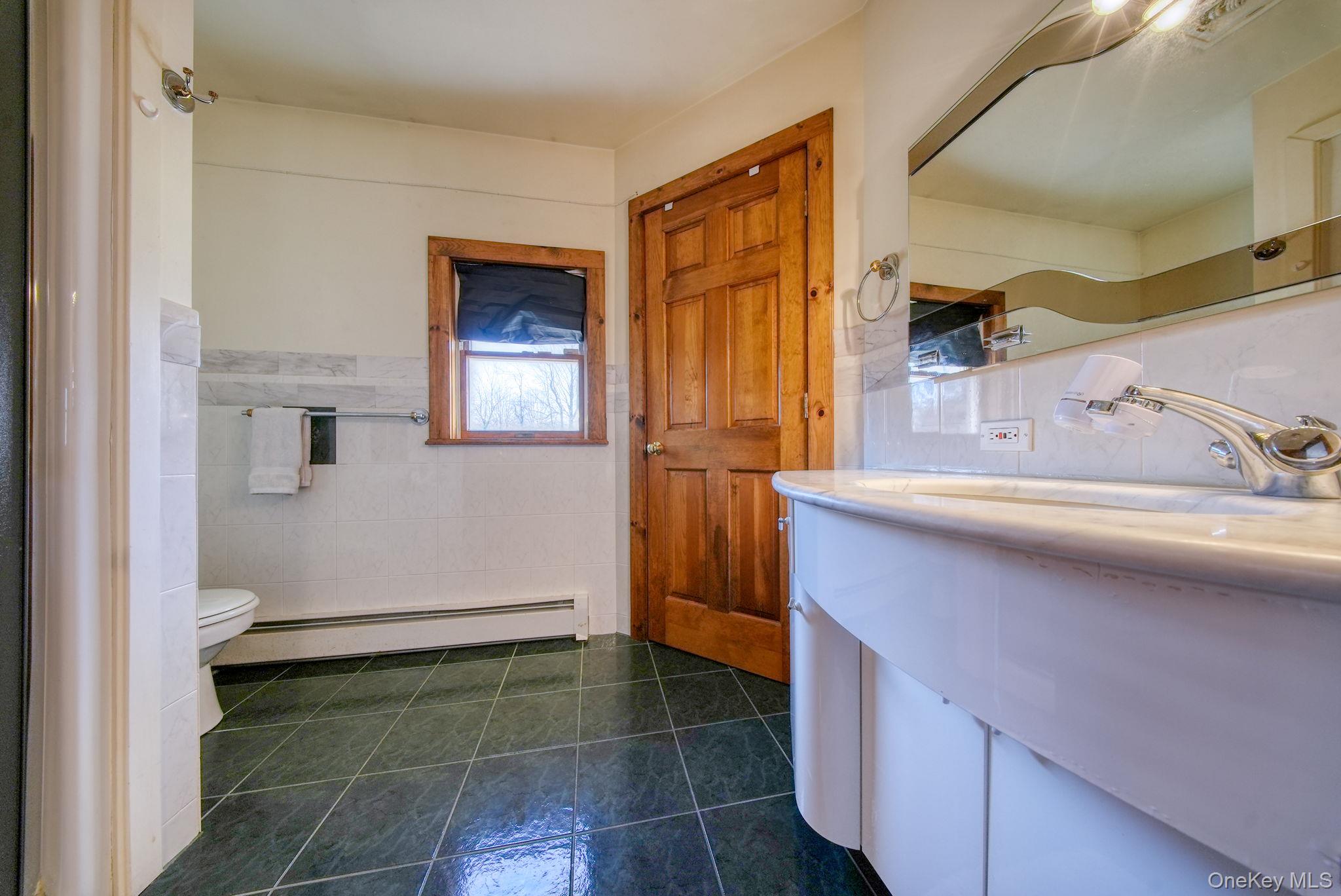 158 Wade Road Liberty, NY 12754 - Photo 14 of 40 a bathroom with a sink and a mirror