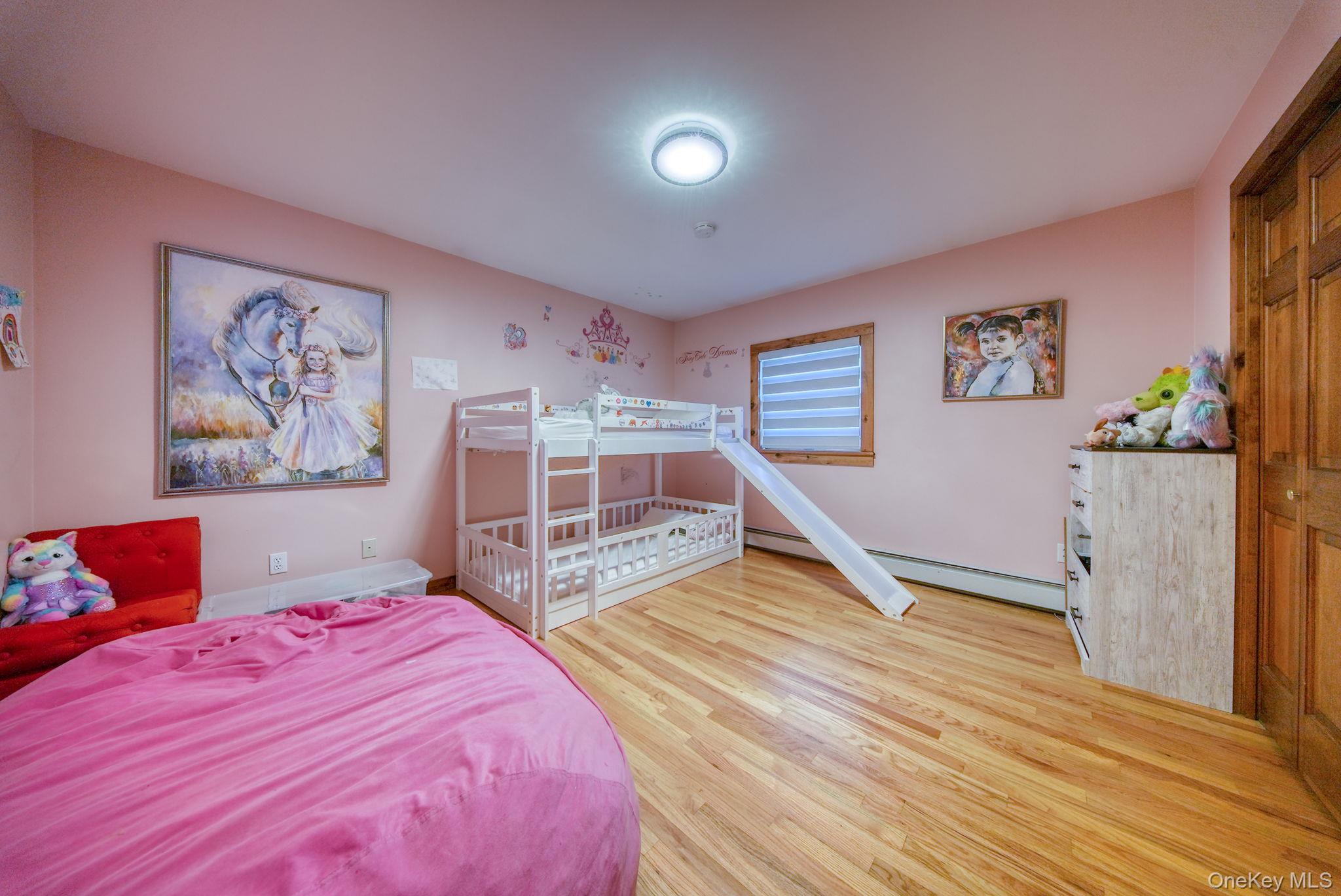 158 Wade Road Liberty, NY 12754 - Photo 16 of 40 a bedroom with a large bed and a chandelier
