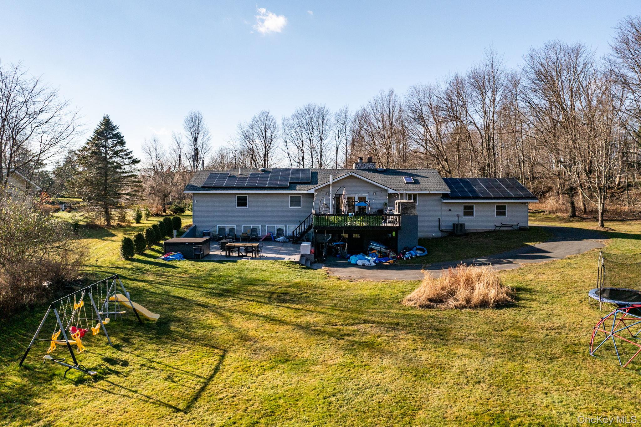 158 Wade Road Liberty, NY 12754 - Photo 17 of 40 a view of a house with swimming pool and sitting area