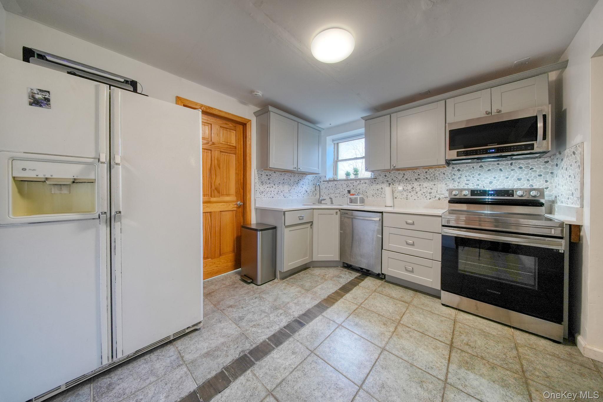 158 Wade Road Liberty, NY 12754 - Photo 22 of 40 a kitchen with stainless steel appliances a stove sink and microwave
