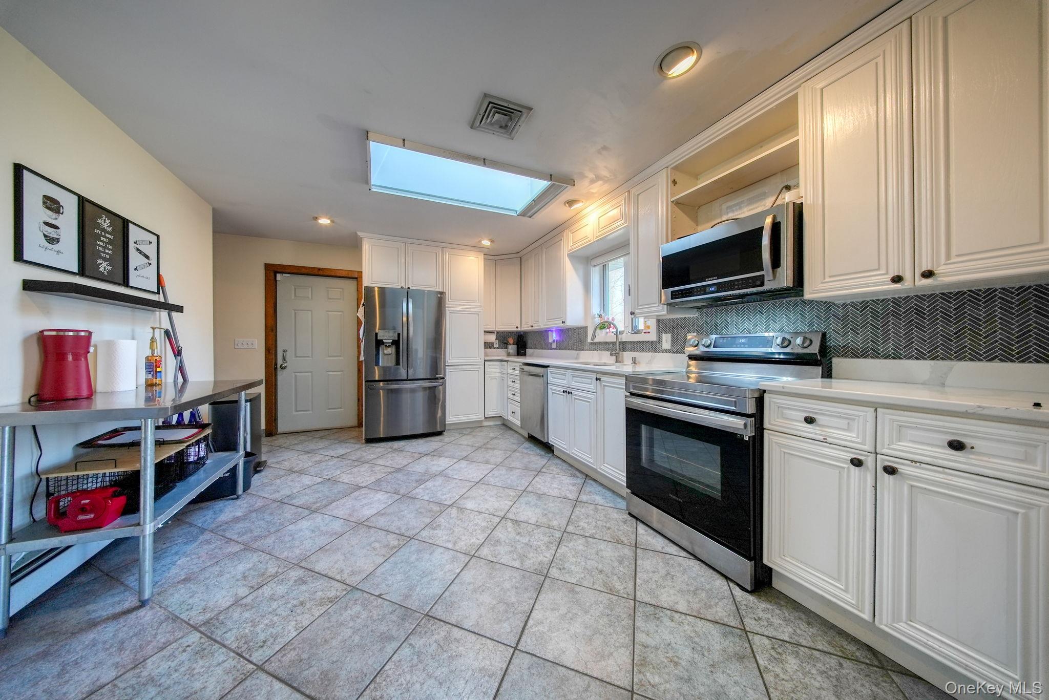 158 Wade Road Liberty, NY 12754 - Photo 8 of 40 a kitchen with stainless steel appliances granite countertop a refrigerator and a stove top oven