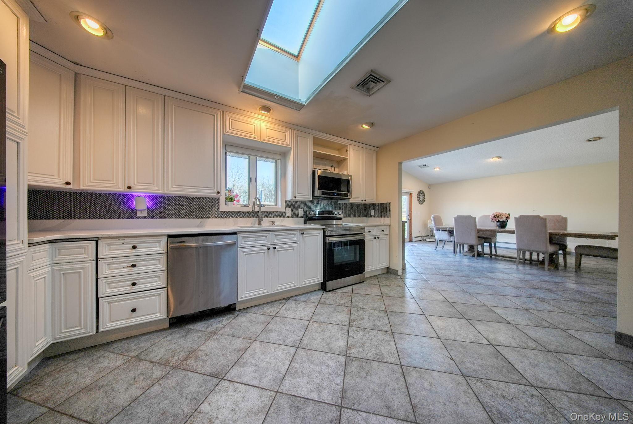 158 Wade Road Liberty, NY 12754 - Photo 9 of 40 a kitchen with cabinets and chairs