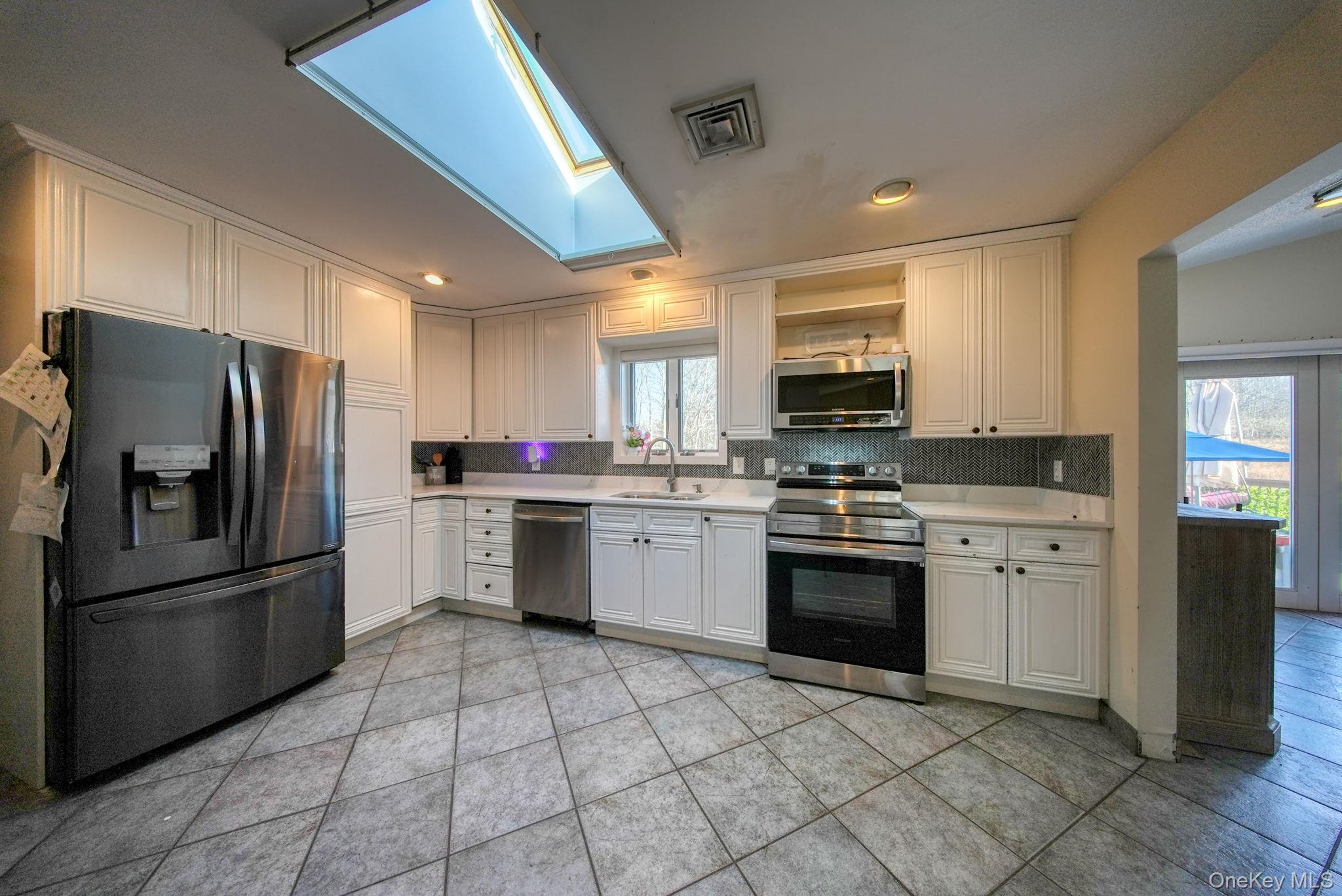 158 Wade Road Liberty, NY 12754 - Photo 10 of 40 a kitchen with granite countertop a refrigerator stove top oven and sink