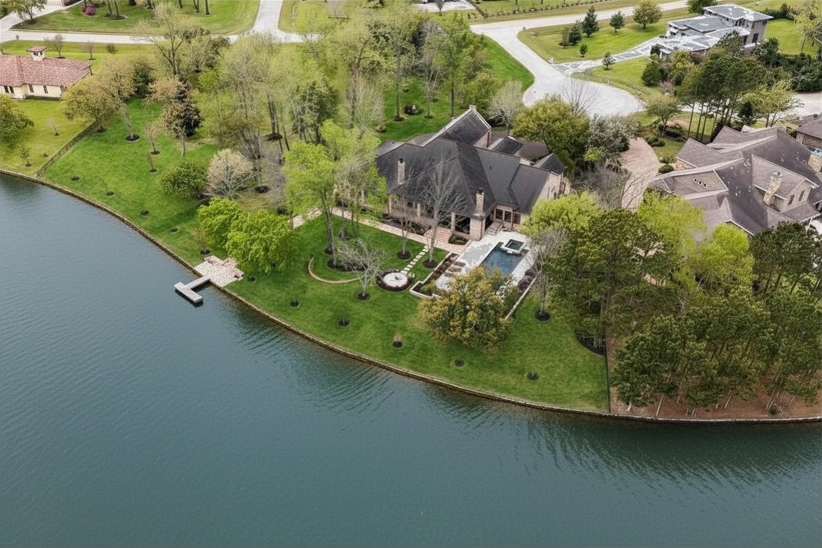 an aerial view of a residential houses with outdoor space and swimming pool