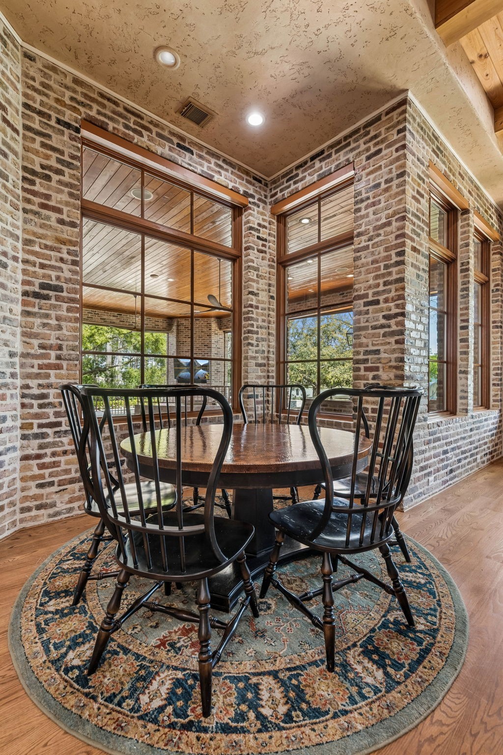 27306 Owosso Court Spring, TX 77386 - Photo 19 of 36 a view of a dining room with furniture large windows and wooden floor