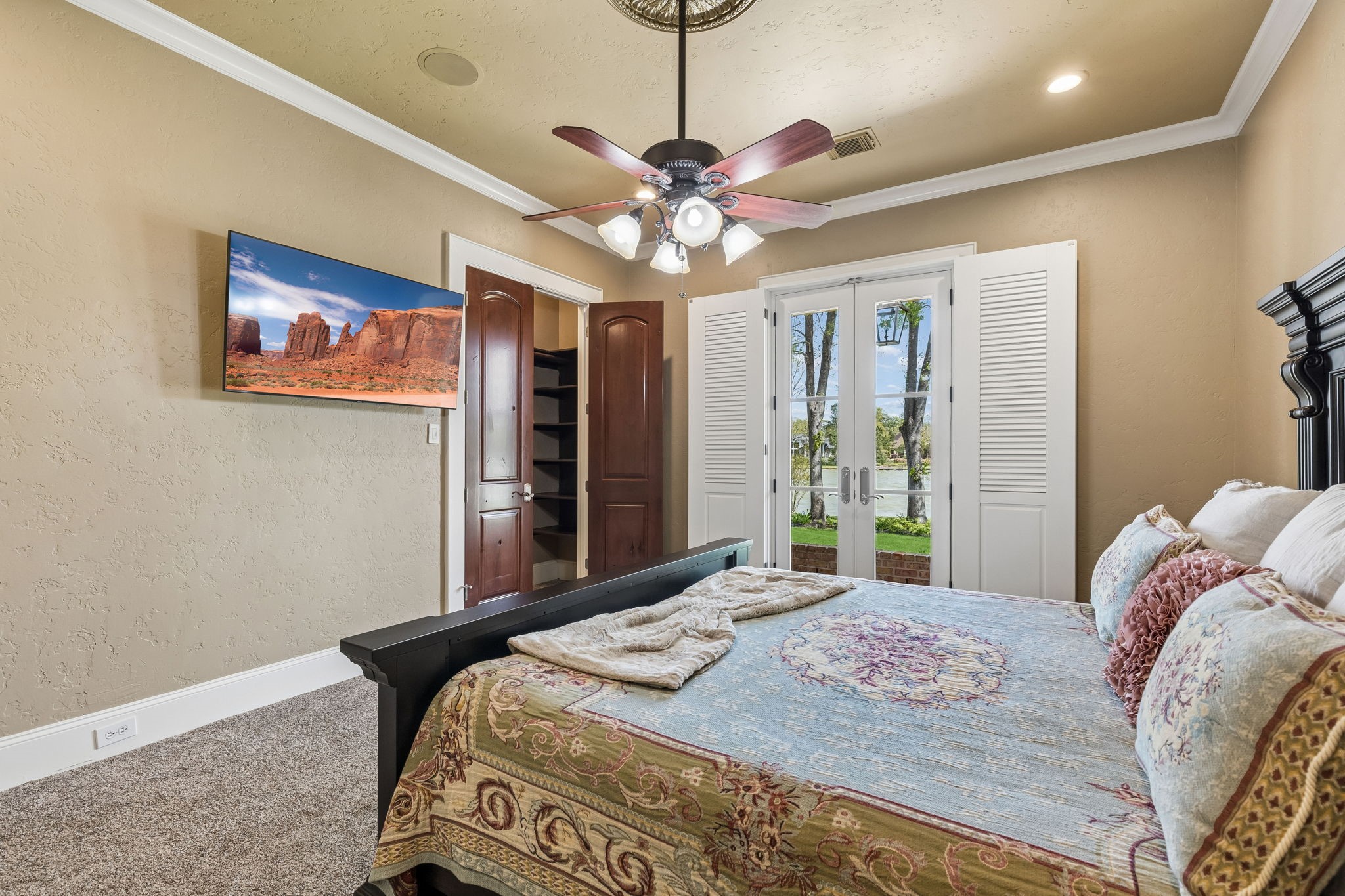 27306 Owosso Court Spring, TX 77386 - Photo 26 of 36 a bedroom with a large bed and a chandelier