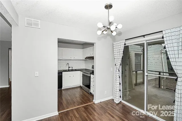 a kitchen with kitchen island a counter top space wooden floor and a ceiling fan