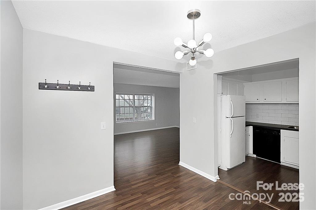 2634 Park Road, Unit D Charlotte, NC 28209 - Photo 12 of 30 a view of an empty room with wooden floor fireplace and a window