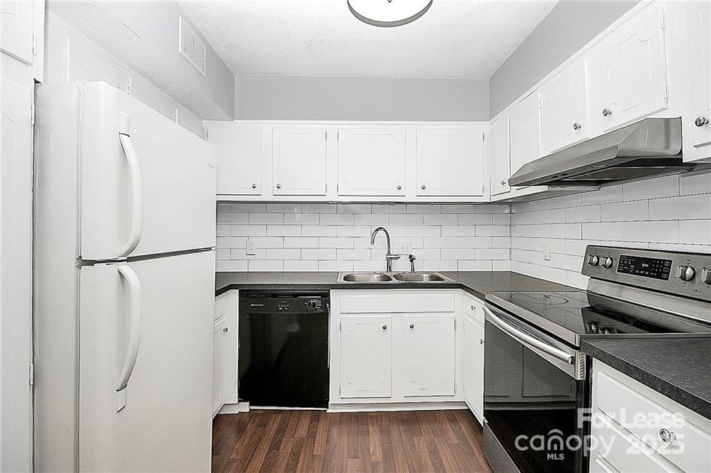 2634 Park Road, Unit D Charlotte, NC 28209 - Photo 13 of 30 a kitchen with stainless steel appliances granite countertop a sink stove and refrigerator