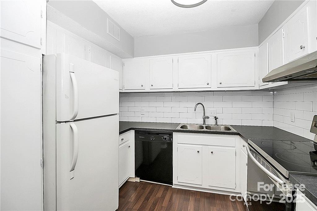 2634 Park Road, Unit D Charlotte, NC 28209 - Photo 14 of 30 a kitchen with granite countertop a sink stove and refrigerator