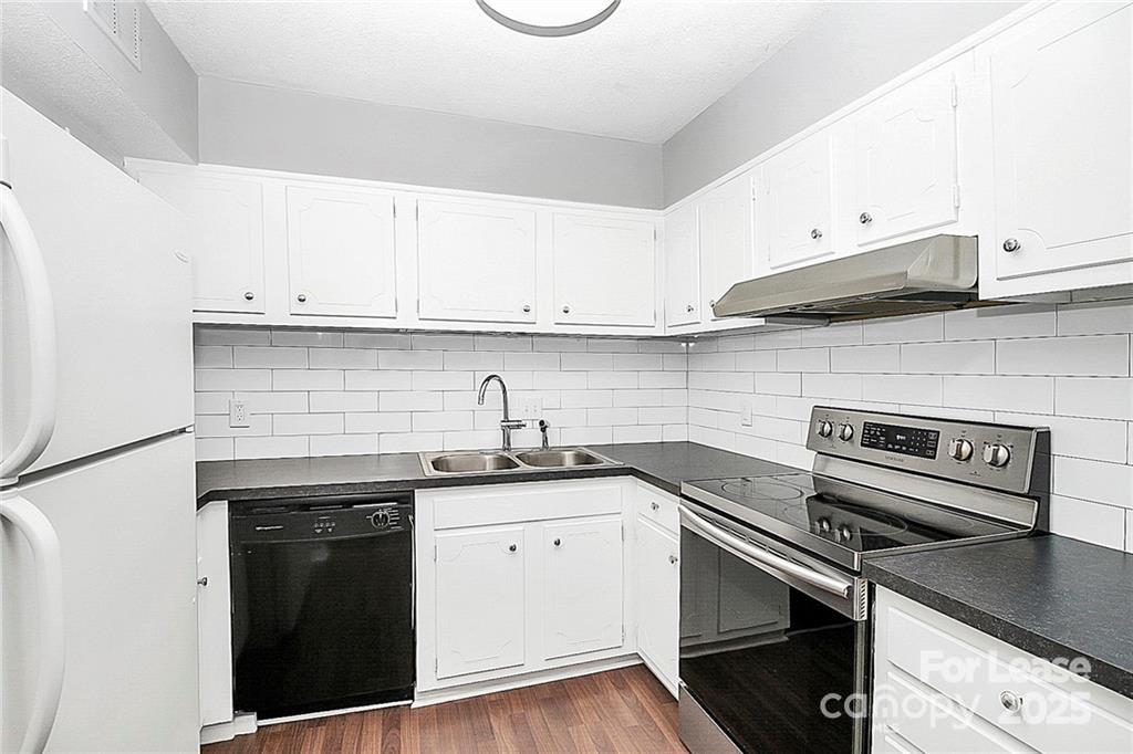 2634 Park Road, Unit D Charlotte, NC 28209 - Photo 15 of 30 a kitchen with granite countertop a sink cabinets and stainless steel appliances