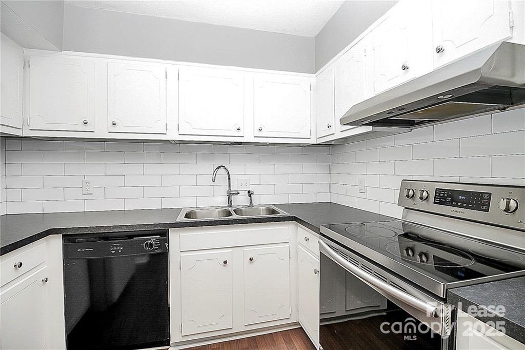 2634 Park Road, Unit D Charlotte, NC 28209 - Photo 16 of 30 a kitchen with granite countertop a sink stainless steel appliances and white cabinets