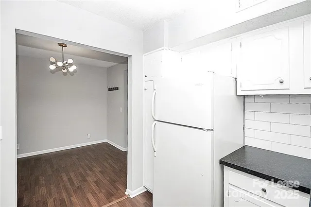 a white refrigerator freezer sitting inside of a kitchen
