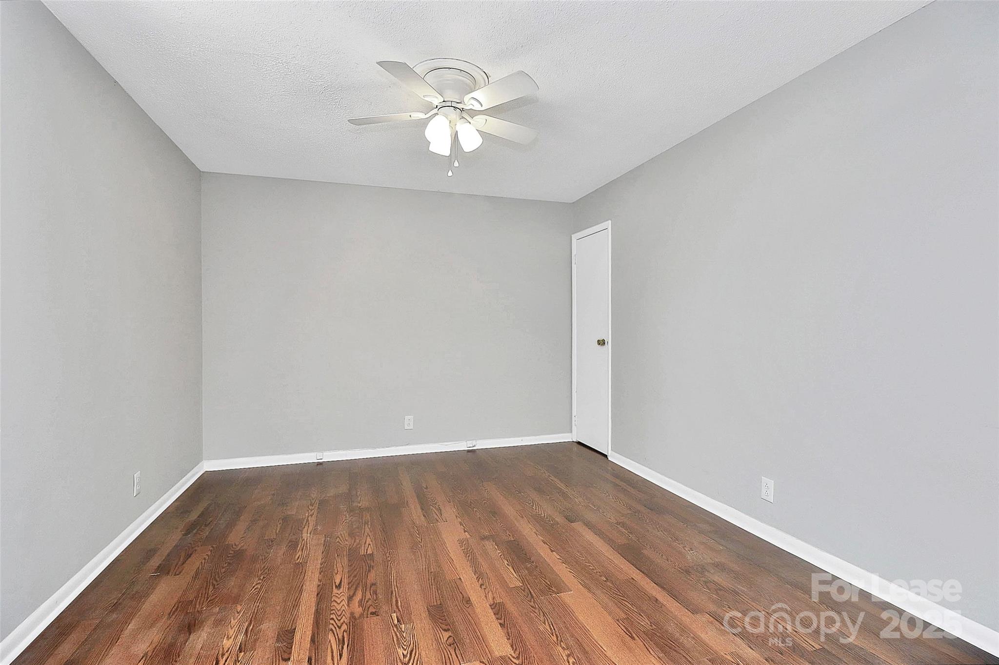 2634 Park Road, Unit D Charlotte, NC 28209 - Photo 21 of 30 a view of a room with wooden floor and a ceiling fan