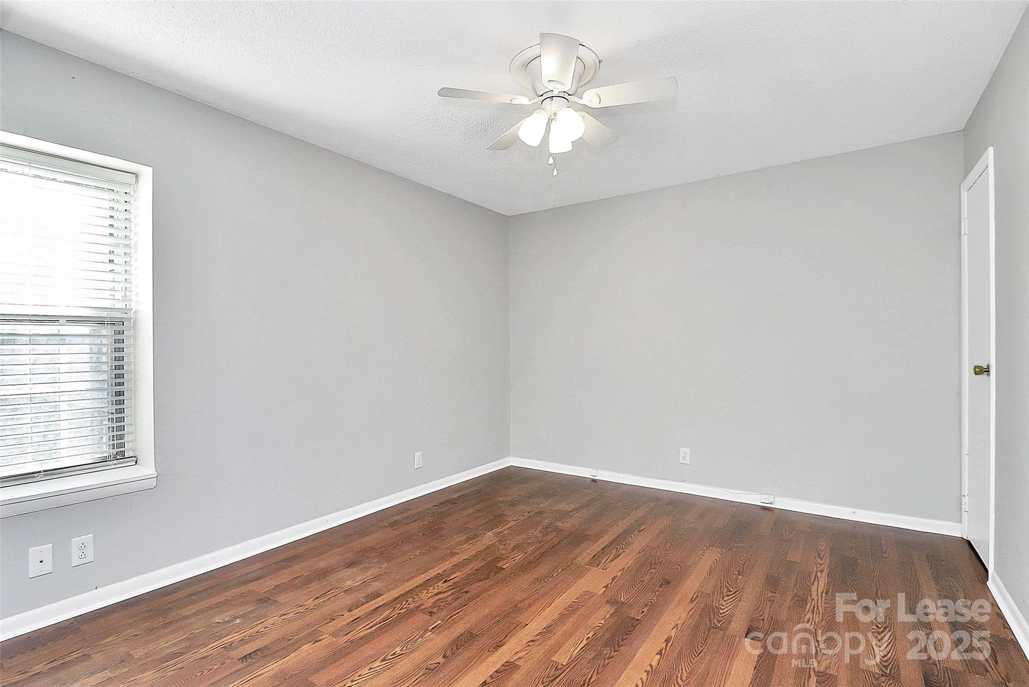 2634 Park Road, Unit D Charlotte, NC 28209 - Photo 22 of 30 wooden floor in an empty room with a window