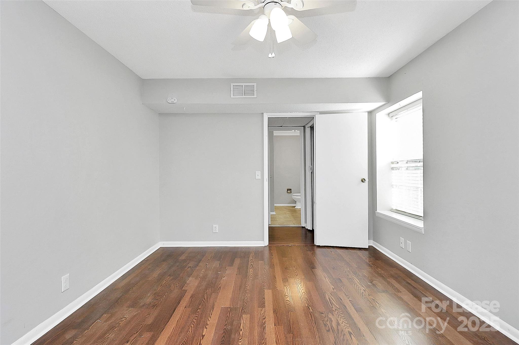 2634 Park Road, Unit D Charlotte, NC 28209 - Photo 24 of 30 wooden floor in an empty room with a window