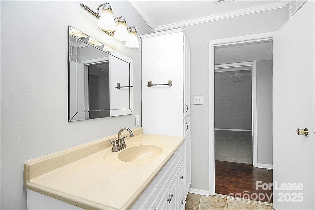 2634 Park Road, Unit D Charlotte, NC 28209 - Photo 27 of 30 a bathroom with a sink a mirror and a shower