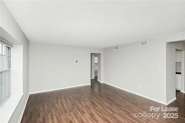 an empty room with wooden floor