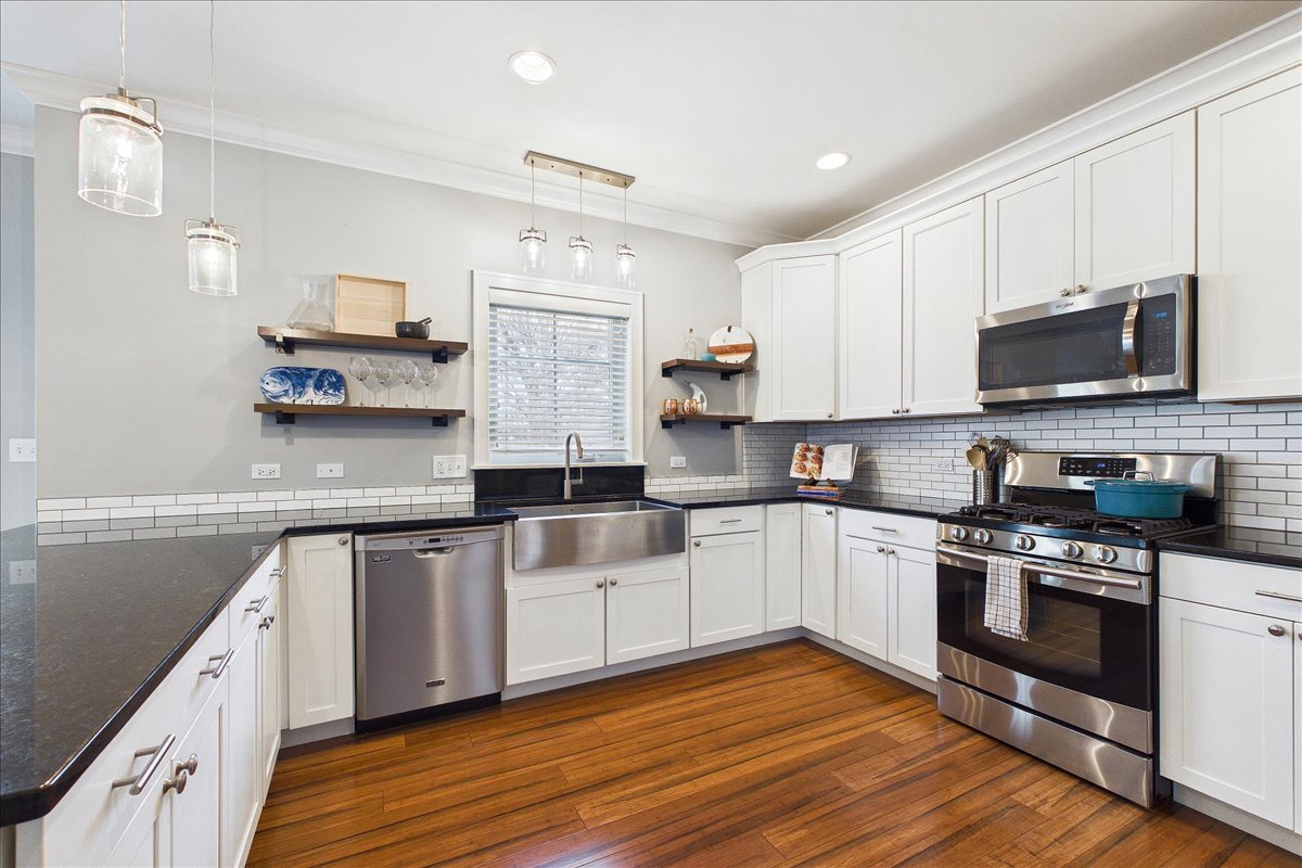 811 Michigan Street Wheaton, IL 60187 - Photo 11 of 33 a kitchen with stainless steel appliances granite countertop a stove top oven a sink and white cabinets