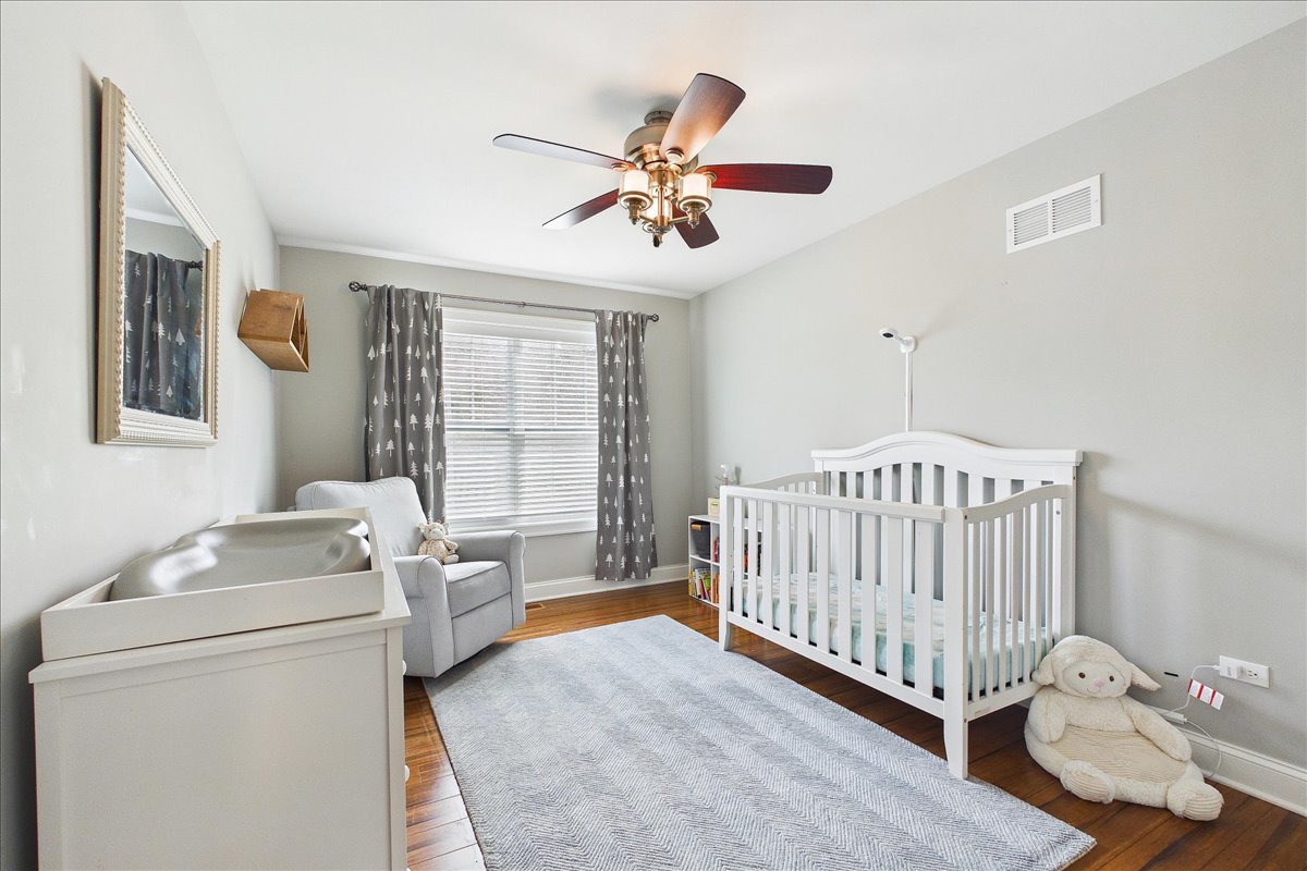 811 Michigan Street Wheaton, IL 60187 - Photo 19 of 33 a bedroom with a bed and a chandelier