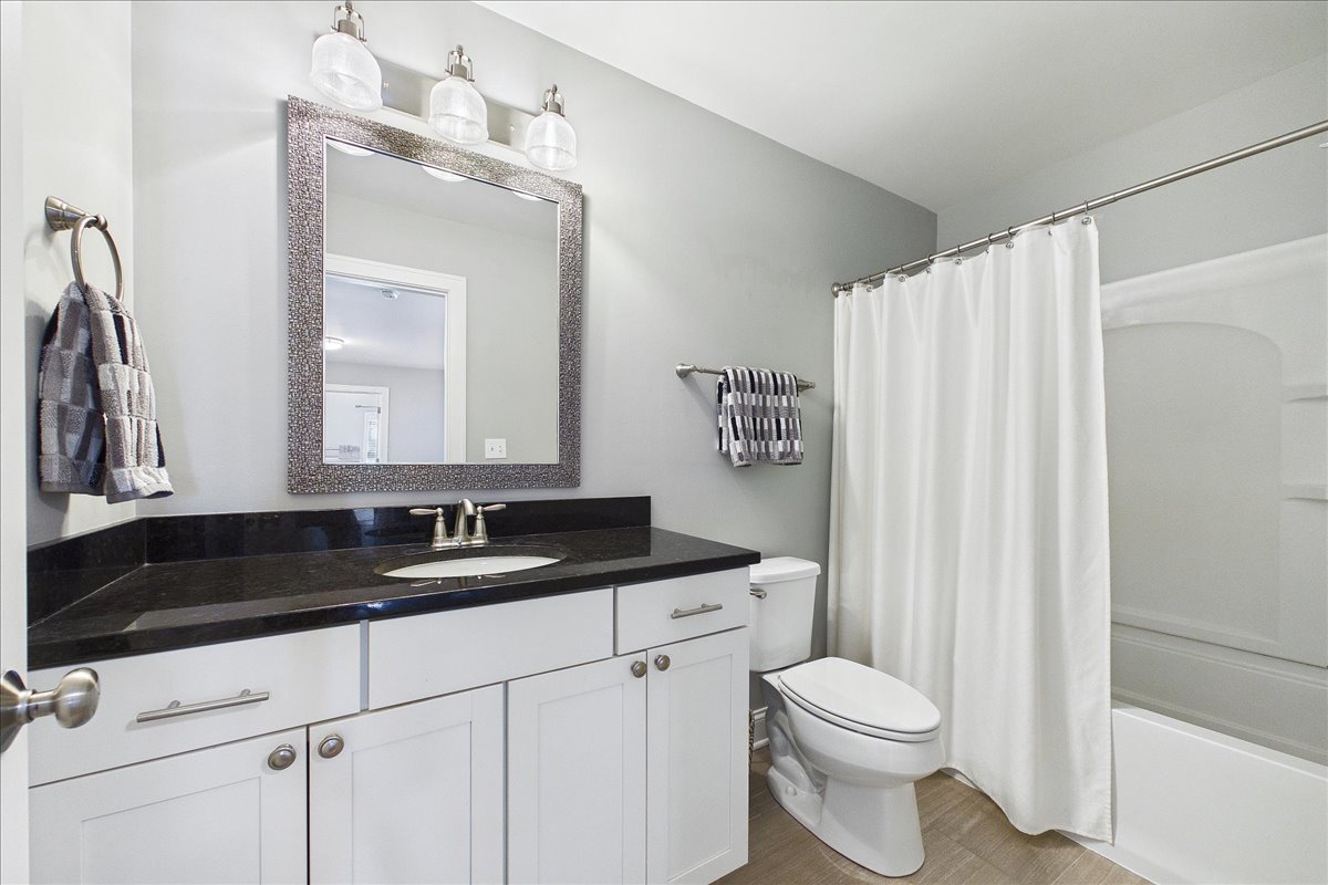 811 Michigan Street Wheaton, IL 60187 - Photo 20 of 33 a bathroom with a granite countertop sink mirror vanity and toilet