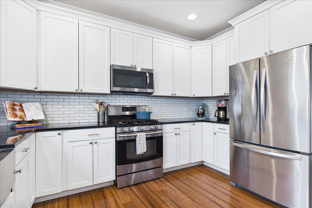 811 Michigan Street Wheaton, IL 60187 - Photo 10 of 33 a kitchen with cabinets stainless steel appliances a sink and wooden floor
