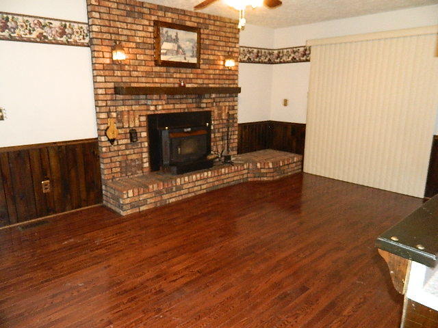 4788 Seven Hills Road Clinton, IL 61727 - Photo 25 of 46 a living room with a fireplace furniture and a wooden floor