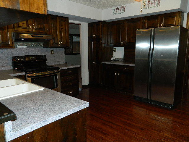 4788 Seven Hills Road Clinton, IL 61727 - Photo 28 of 46 a kitchen with a refrigerator and a stove top oven
