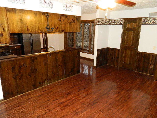 4788 Seven Hills Road Clinton, IL 61727 - Photo 29 of 46 a view of a room with wooden floor and furniture