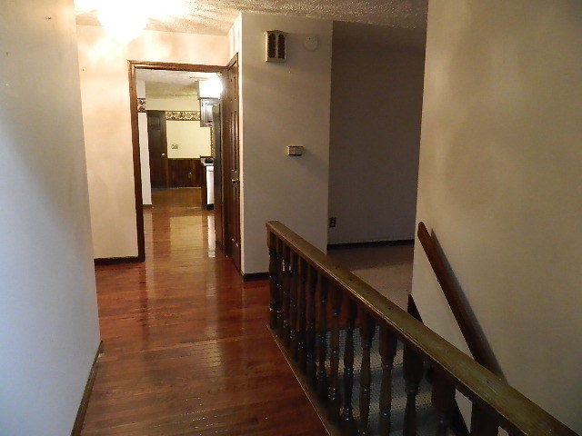 4788 Seven Hills Road Clinton, IL 61727 - Photo 36 of 46 a view of a hallway with wooden floor