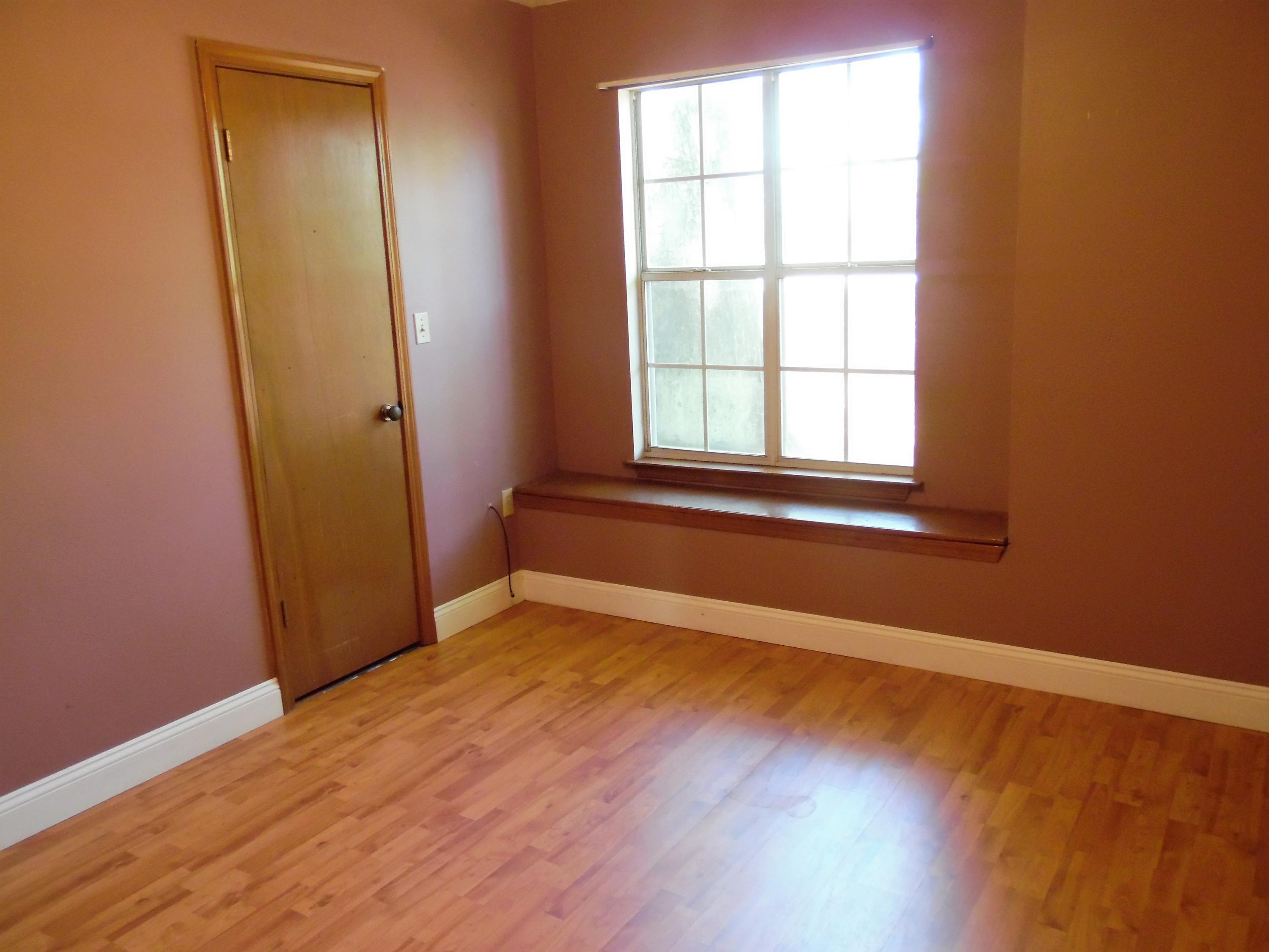 2580 Kingston Road Crestview, FL 32536 - Photo 16 of 20 an empty room with wooden floor and windows