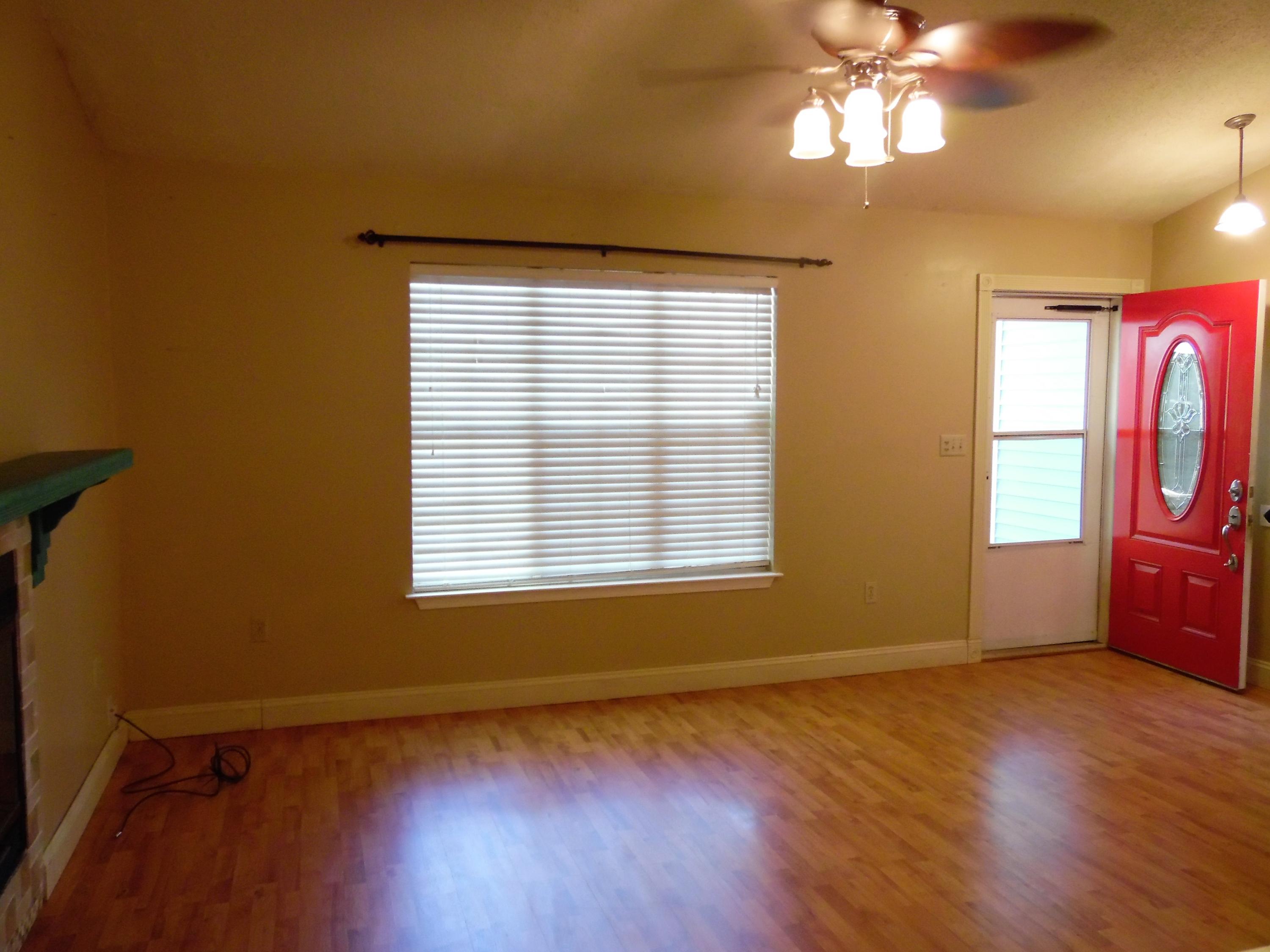 2580 Kingston Road Crestview, FL 32536 - Photo 3 of 20 a view of an empty room with a window and wooden floor
