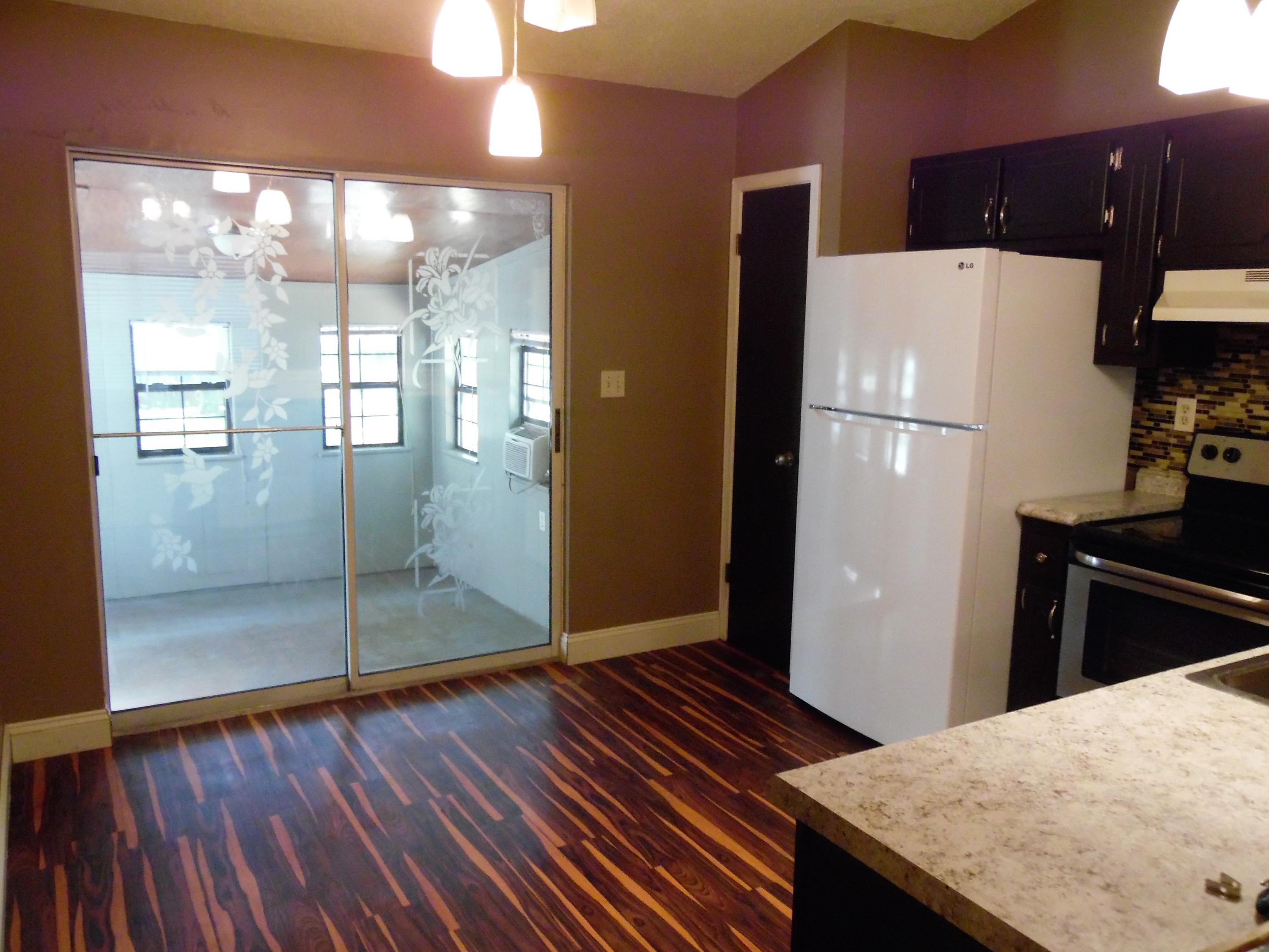 2580 Kingston Road Crestview, FL 32536 - Photo 7 of 20 a kitchen with a refrigerator and wooden floor