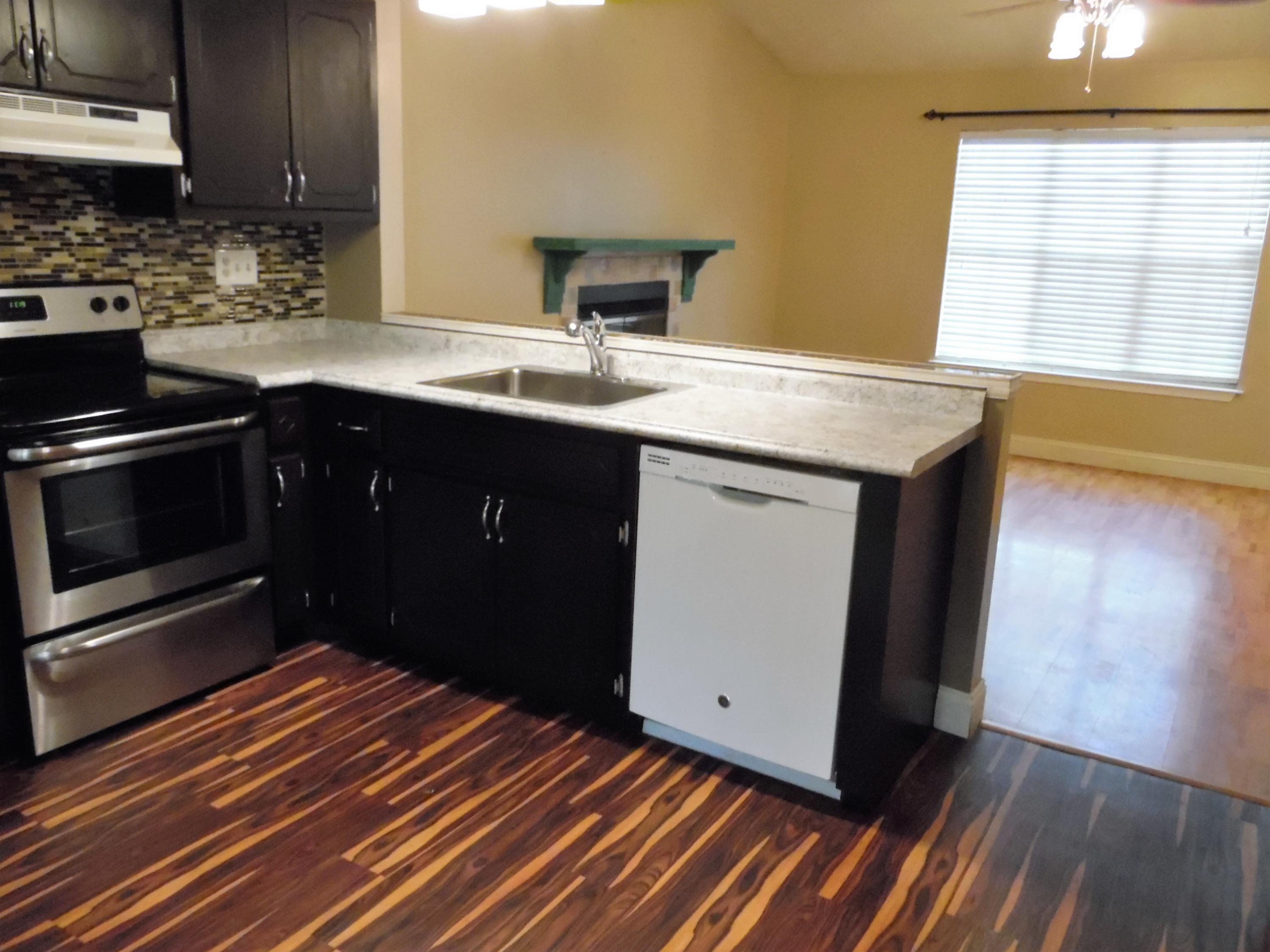 2580 Kingston Road Crestview, FL 32536 - Photo 8 of 20 a kitchen with stainless steel appliances a sink stove and cabinets