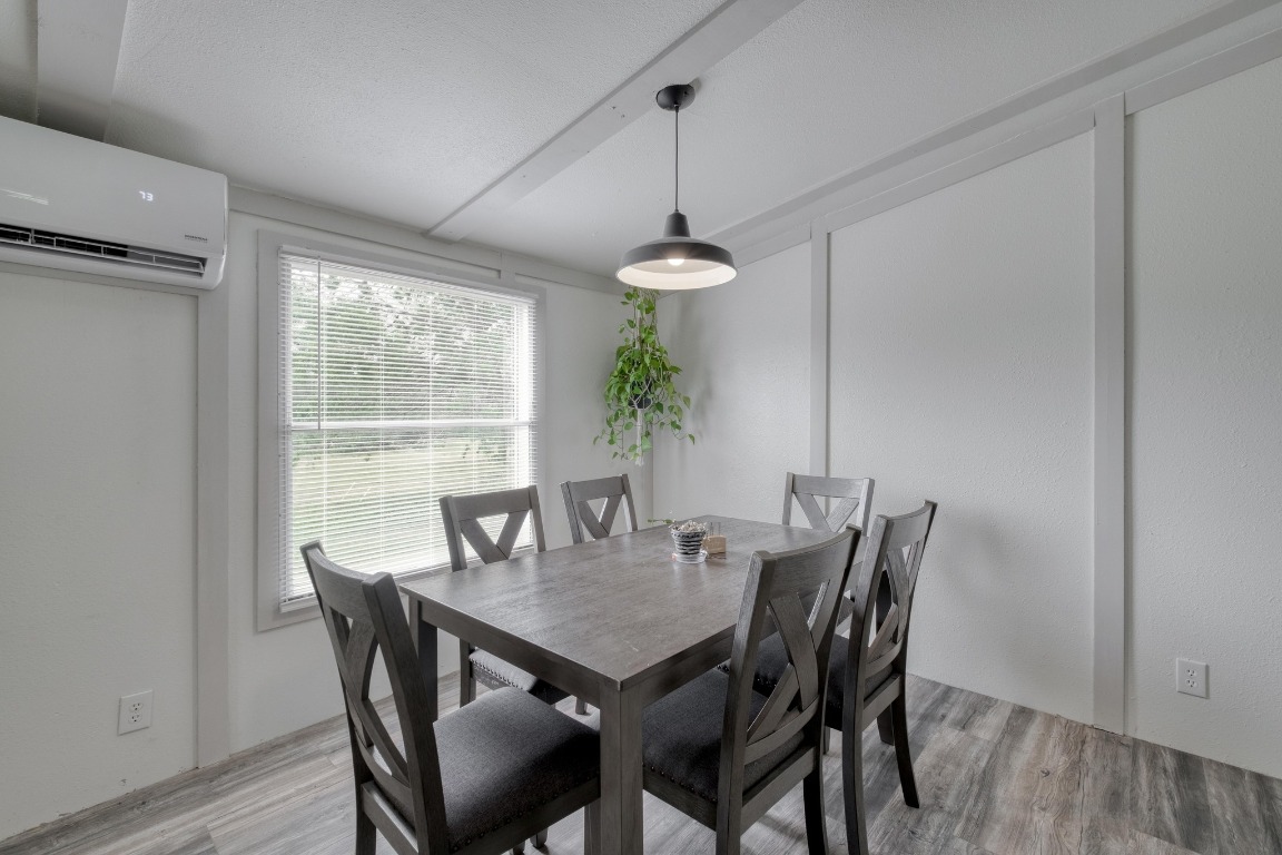 209 Fallwell Street Liberty Hill, TX 78642 - Photo 13 of 25 a view of a dining room with furniture window and wooden floor