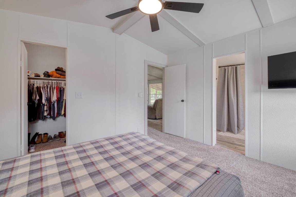 209 Fallwell Street Liberty Hill, TX 78642 - Photo 16 of 25 a bedroom with a bed and a chandelier