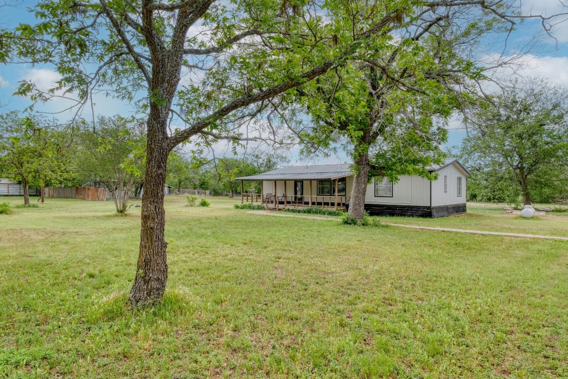 209 Fallwell Street Liberty Hill, TX 78642 - Photo 2 of 25 a front view of a house with a garden