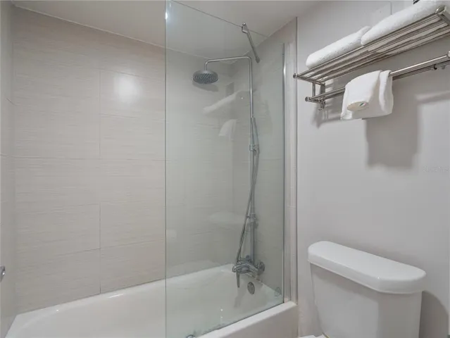 a bathroom with a shower and a toilet