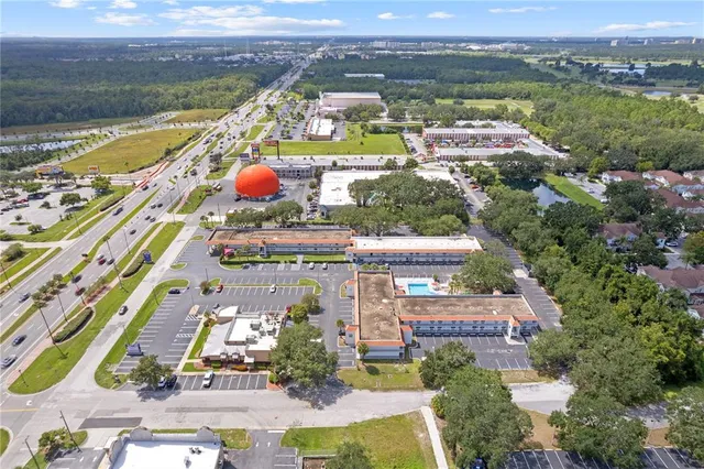 an aerial view of residential houses with outdoor space and river