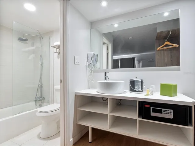 a bathroom with a double vanity sink toilet and shower