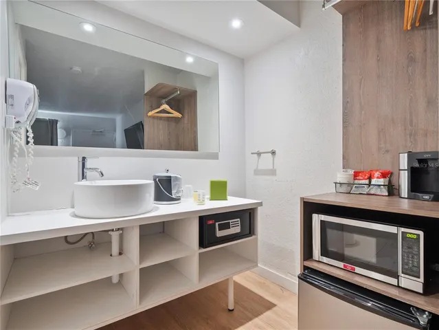 a kitchen with stainless steel appliances a stove a sink and a microwave