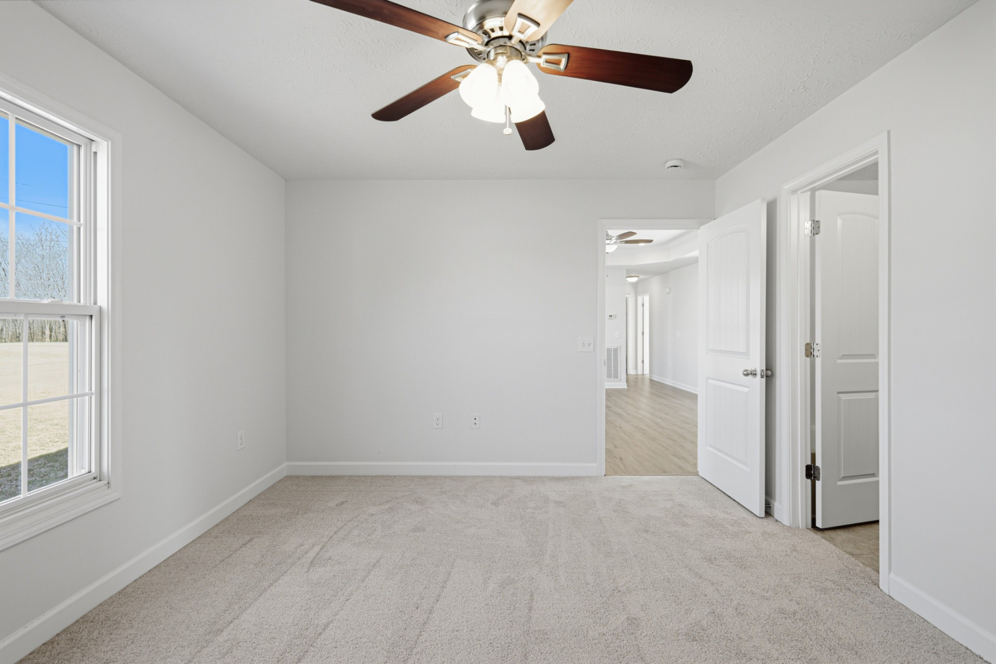 91 Creek Chase Road Manchester, TN 37355 - Photo 18 of 30 an empty room with chandelier fan and windows