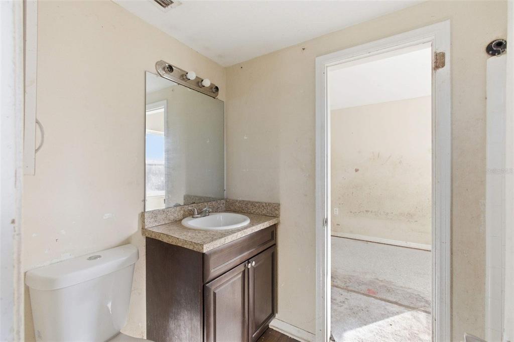 762 Valencia Avenue Orange City, FL 32763 - Photo 16 of 39 a bathroom with a granite countertop sink and a mirror