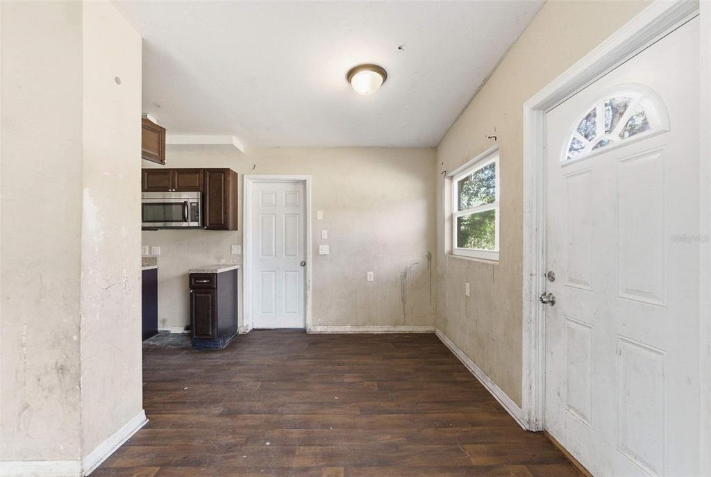 762 Valencia Avenue Orange City, FL 32763 - Photo 19 of 39 a view of a kitchen with an entryway and a fireplace