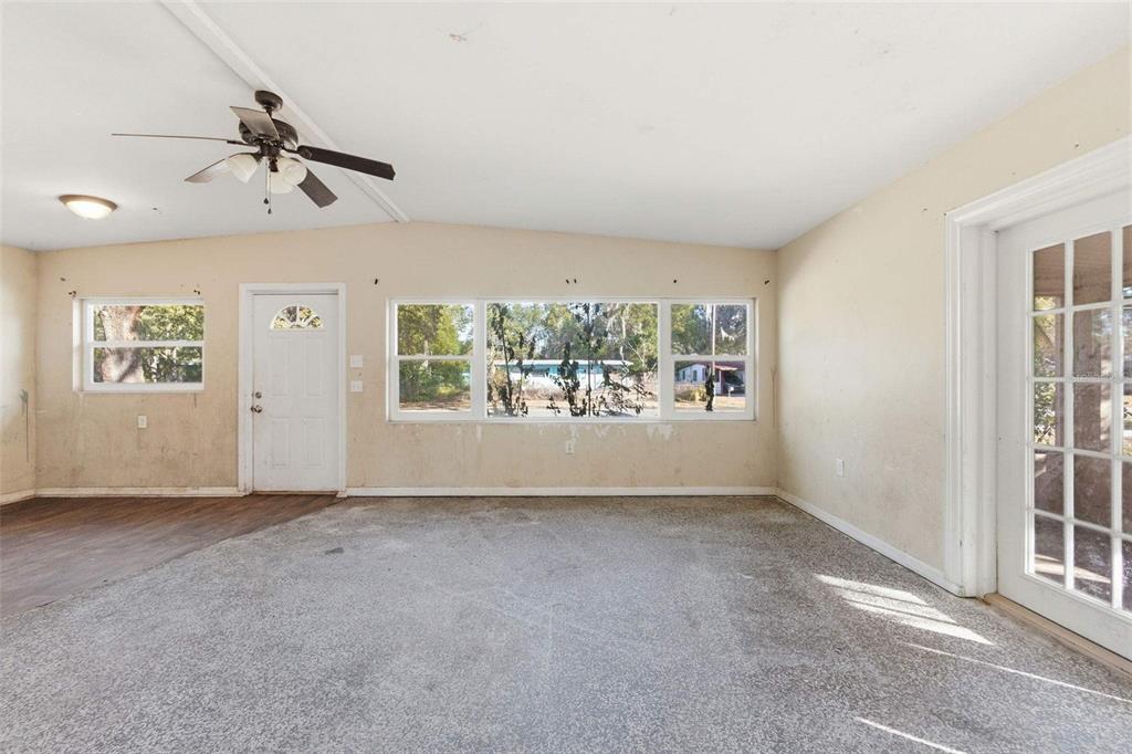 762 Valencia Avenue Orange City, FL 32763 - Photo 3 of 39 an empty room with windows and chandelier fan